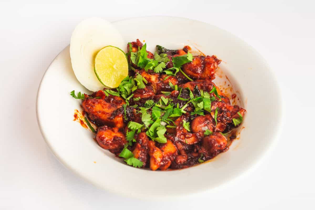 Chilli Chicken topped with corriander, and side of onion and lemon