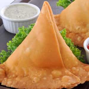 Samosa,Deep fried crispy flour snack with savoury filling of spiced potatoes, onions and peas